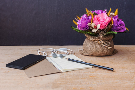 Pencil with paper and headphone and smartphone on wooden table still life tone, Table of composerの写真素材