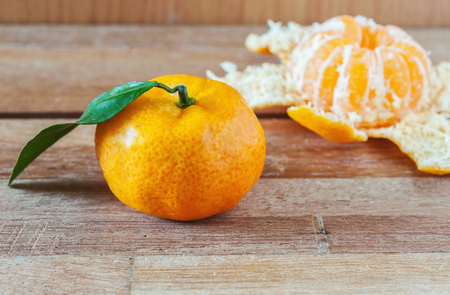 Orange fruit on wooden table background in still life toneの写真素材