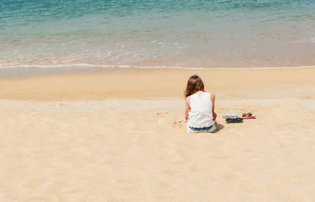 Some people relax on the white sand beach and blue sea with copy spaceの写真素材