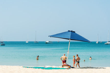 Phuket,Thailand - March 01, 2016: Some people relax on the white sand beach and blue sea with blue sky backgroundのeditorial素材