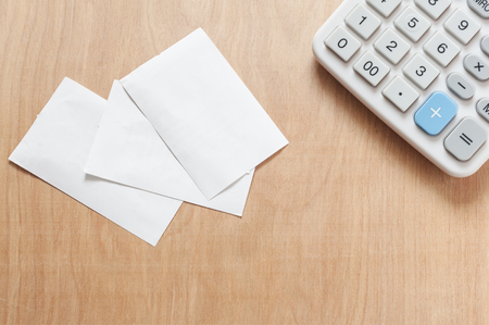 Bill and calculator on wooden, Macro paper bill and calculator on wooden texture, Bill for income and expenditure with copy spaceの写真素材