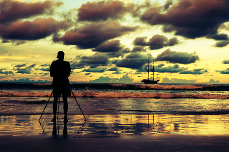 Vintage nature background, Photographer shooting image on the beach with color of the sunset in twilight and over dark toneの写真素材
