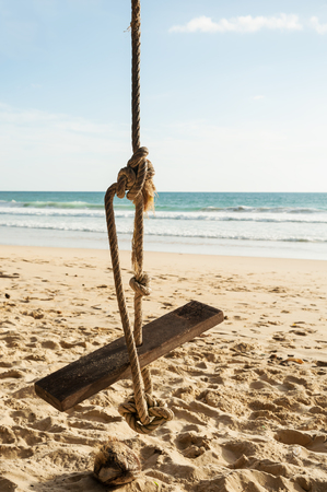 Cradle with sand beach and blue sea in blue sky backgroundの写真素材