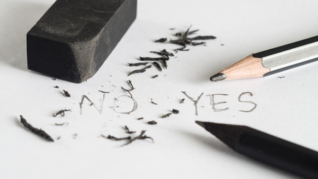Mistake erase concept, Change concept, From no to yes, Black pencil with black eraser on white backgroundの写真素材