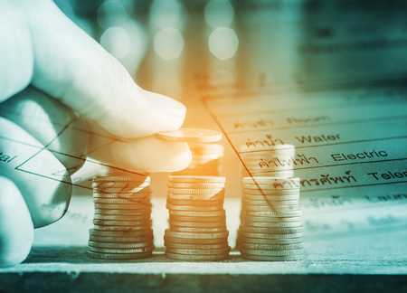 Double exposure rows of coins with utility bill and account for finance and banking concept