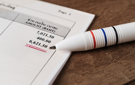 Save money concept, Utility bill with pen on paper bill backgroundの写真素材