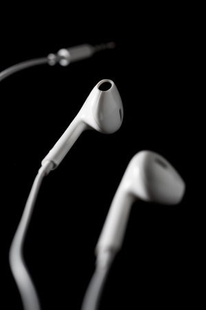 Ear headphone white on black backgroundの写真素材