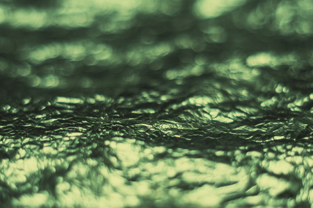Glitter bokeh light abstract vintage green color blurred on black backgroundの写真素材