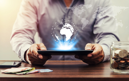 Online banking and internet banking and internet networking people concept, Saving money and account banking for finance business network concept, Business man with laptop and coin money on business network globalの写真素材