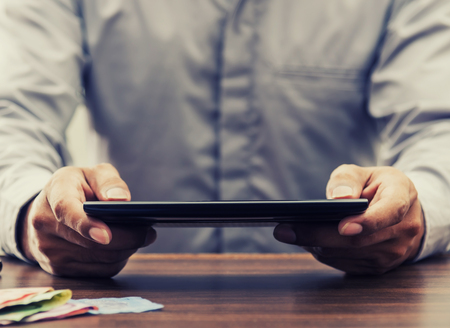 Online banking and internet banking concept, Saving money and account banking for finance business concept, Business man with laptop and coin money on business office tableの写真素材