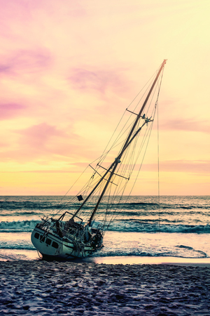 Boat on the sand beach sunset or sunrise in twilight and colorful of cloud sky and sun, Seascape landscape nature and relaxation and summer vacation conceptの写真素材