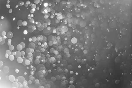 Christmas light bokeh silver blurred background for designの写真素材