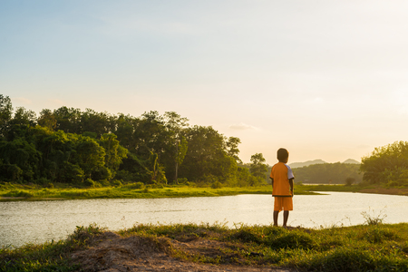 Child look at the river with sky nature in sunlightの写真素材