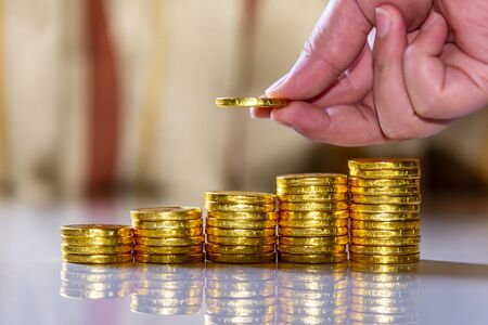 Save money and account banking for finance business concept, Hand with coin money on blurred...