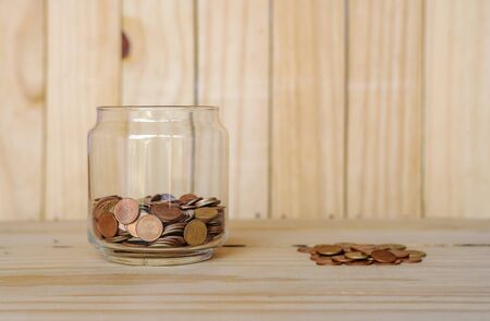 Save money and account banking for finance business concept, Coin money on blurred wooden backgroundの写真素材