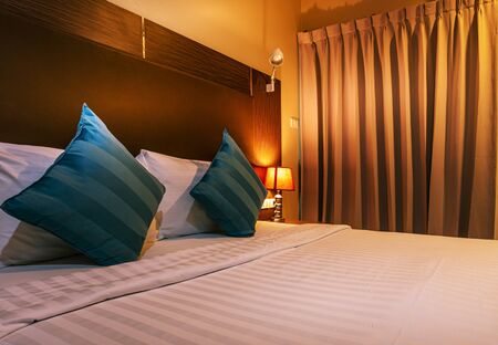 Happy bedroom and comfortable mattress and pillows over light at window, Room and interior conceptの写真素材