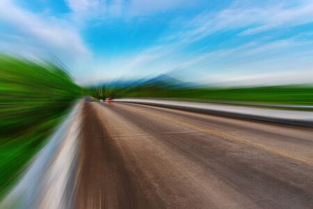 Blurred asphalt road blurred blue sky backgroundの写真素材