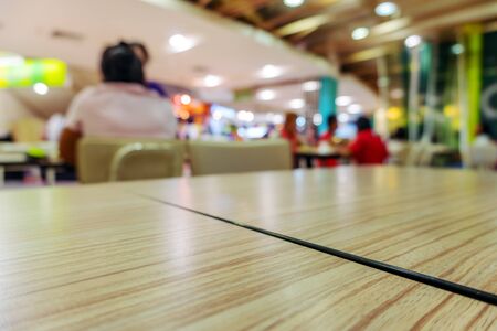 Table in food court at shopping mall blurred background