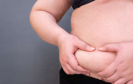 Fat woman., Shape up healthy stomach muscle, and diet lifestyle, to reduce belly concept.の写真素材