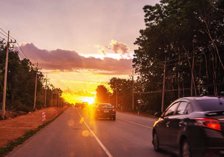 Pattalung, Thailand - August 29, 2020 : Car on road with colorful of sunset or sunrise in twilightのeditorial素材