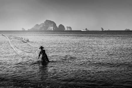 Fisher man fishing in the sea beach countryside with morning light, Black and white and monochrome styleの写真素材