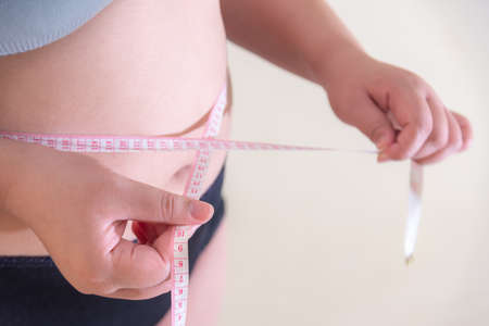 Fat women., Belly women Overweight, Shape up healthy stomach muscle, and diet lifestyle, to reduce belly concept.の写真素材