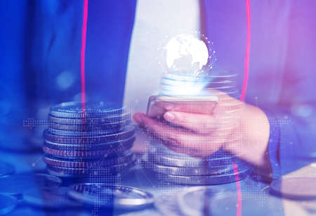 Double exposure, Online banking and internet banking and people networking account banking finance concept, Young women with laptop, phone, cellphone, tablet, smartphone mobile, and coin money on blurred backgroundの写真素材