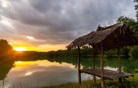 View of Colorful dramatic sky sunset or sunrise with clouds background on Water River in Forest, Sky with cloud in nature and travel concept.の写真素材