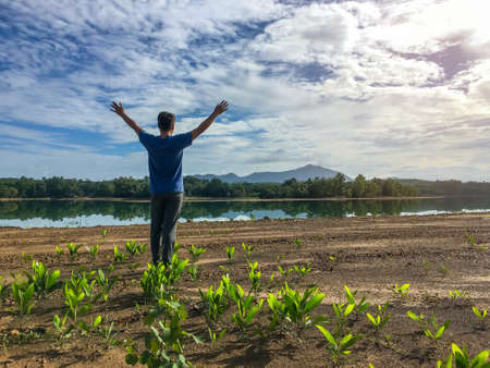 The man relax at river with sunshine and color of cloud sky in moning light