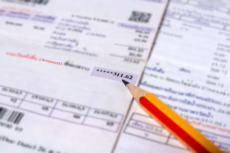 Utility energy bill with pencil blurred background, Bill and saving conceptの写真素材
