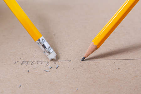 Close up a pencil writing crooked line and close up a sharpened pencil writing a straight line.