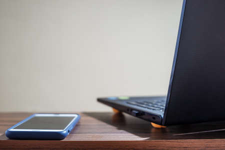 Technology network and online banking and internet banking and networking people concept, Computer Notebook with smartphone mobile on blurred backgroundの写真素材