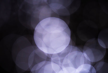 Light abstract dark bokeh christmas circle color glitter blurred black backgroundの写真素材
