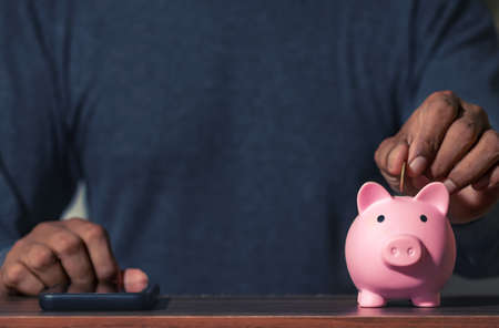 Save money and account banking for finance concept, Piggy bank with coin on blurred background, Save Monney for Investors Using Internet to Trade Stocks or Trade Fundの写真素材