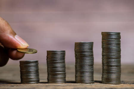 Save money and account banking for finance concept, Hand bank with coin on blurred background, Save Monney for Investors Using Internet to Trade Stocks or Trade Fundの写真素材