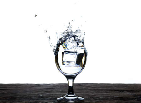 The image of pouring drinking water, into a glass, that makes one feel refreshed isolated on white...