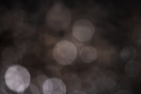 Light abstract dark bokeh christmas circle color glitter blurred black backgroundの写真素材