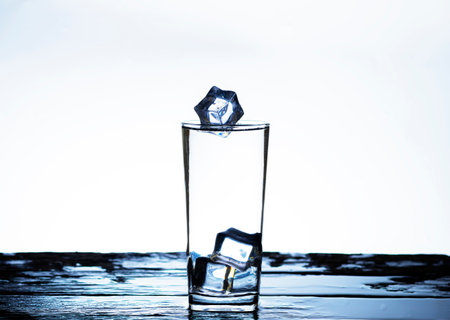 The image of pouring drinking water, into a glass, that makes one feel refreshed on blurred white background, Splashing water, Sparkling waterの写真素材