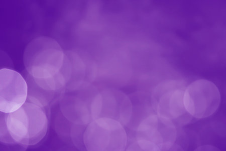 Light abstract purple bokeh christmas circle color glitter blurred black backgroundの写真素材