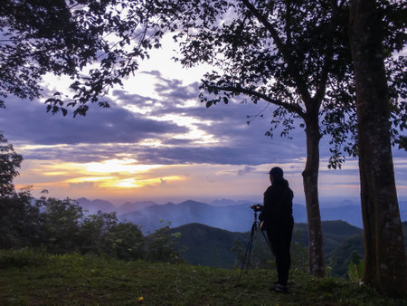 Photography lifestyle and happiness in nature on mountain, Some body shooting photo in sky sunset and colorful of cloud sky in twilightの写真素材