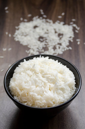 Rice in cup on wooden table blurred backgroundの写真素材