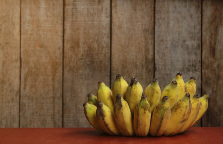 Banana fruit with wooden table on blurred backgroundの写真素材