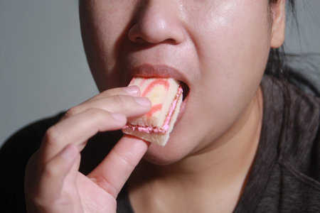 Woman eating cake deliciously, Soft blurred background