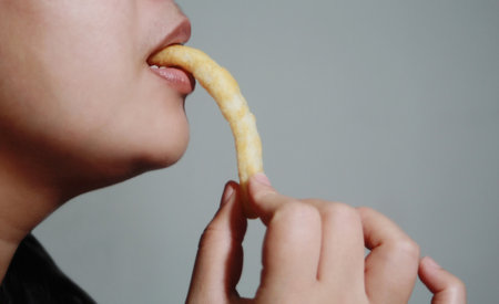 Woman eating crispy pastries, It is a popular street food that is delicious and commonly found in...