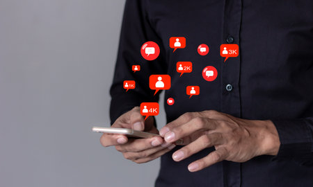 Follow Comment and Like concept, Social Media, Man using smart phone mobile with, Social Media, on soft blurred backgroundの写真素材
