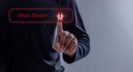 Young man hand touching Shut Down button press power OFF