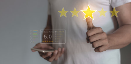 Customer Review, Young Man holding smartphone mobile hand touching five star to review and give 5...