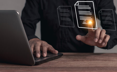 Young man with laptop hand touching to sign a business contract online, Online business contract, Electronic signature, Digital documents, Future business contract signingの写真素材