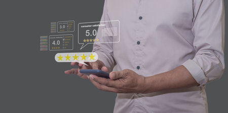 Consume Satisfaction, Young Man hand Holding, Using smartphone mobile with five star to review and give 5 stars with very good results in service, Good review 5 star rating choice feedbackの写真素材