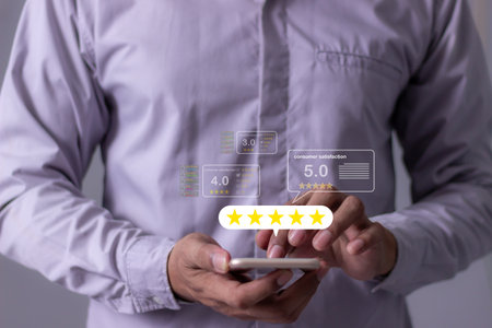 Consumer Satisfaction, Review, Young Man hand uses smartphone mobile with five star to review and give 5 stars with very good results in service, Good review 5 star rating choice feedbackの写真素材